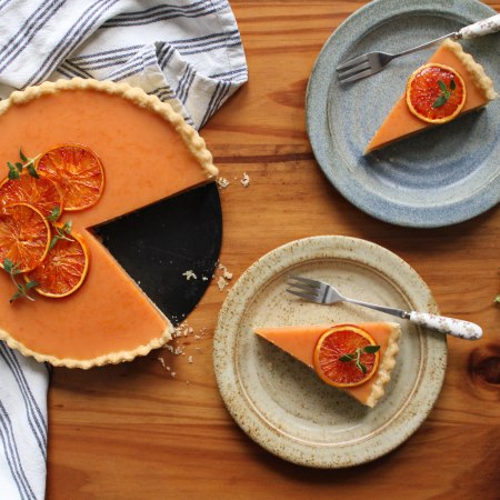 Vegan blood orange tart with two slices out